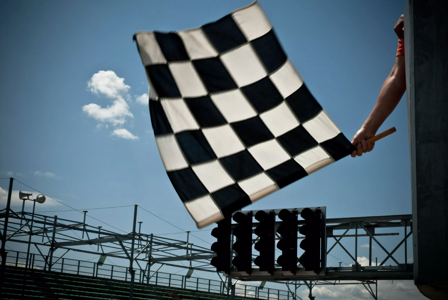 Waving the checkered flag at a car race