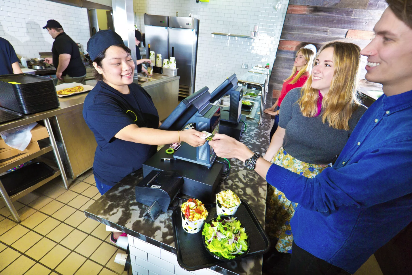 Restaurant employee interacting with customers